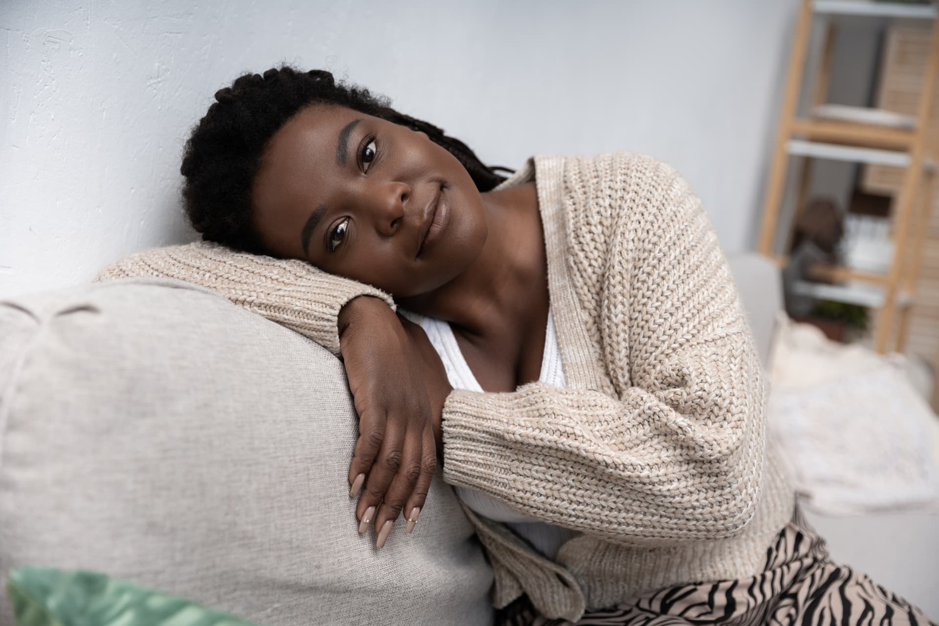 A woman resting peacefully on a sofa